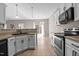 Modern kitchen boasts white cabinets, stainless steel appliances, and breakfast bar overlooking the dining area at 40 Paddle Wheel Ct, Franklinton, NC 27525