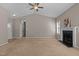 Inviting living room with a cozy fireplace, ceiling fan, and easy access to the hallway and backyard at 40 Paddle Wheel Ct, Franklinton, NC 27525