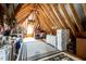 Spacious attic provides ample storage with exposed wooden beams and a bright window at 44 Ashwood Dr, Chapel Hill, NC 27516