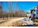 Backyard with wrought iron fence, lush lawn and a stone patio with outdoor seating at 44 Ashwood Dr, Chapel Hill, NC 27516