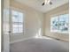 Bright bedroom featuring neutral paint, carpet flooring, and large windows providing natural light at 44 Ashwood Dr, Chapel Hill, NC 27516