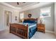 Bright bedroom featuring a tray ceiling, large windows, and wooden furniture at 44 Ashwood Dr, Chapel Hill, NC 27516
