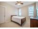 Cozy bedroom featuring a full-size bed, light carpeting, neutral paint, and abundant natural light at 44 Ashwood Dr, Chapel Hill, NC 27516