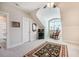 Bonus room features a charming arched window, rocking chair and ensuite bathroom at 44 Ashwood Dr, Chapel Hill, NC 27516