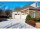 Exterior angle of home featuring a stone and siding facade, three car garage and driveway at 44 Ashwood Dr, Chapel Hill, NC 27516
