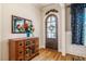 Inviting foyer featuring wood floors, wooden door and decorative flower accents at 44 Ashwood Dr, Chapel Hill, NC 27516