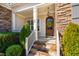 Inviting front porch with stone steps, wood door, and craftsman details at 44 Ashwood Dr, Chapel Hill, NC 27516
