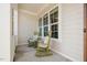 Relaxing front porch featuring rocking chairs, large windows, and ample natural light at 44 Ashwood Dr, Chapel Hill, NC 27516