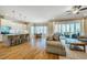 Open-concept kitchen, living, and dining area with hardwood floors and screened-in porch access at 44 Ashwood Dr, Chapel Hill, NC 27516