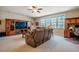 Open concept living room featuring plush seating, neutral carpet, and natural light from large windows at 44 Ashwood Dr, Chapel Hill, NC 27516