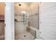 Tiled walk-in shower with frameless glass door and built-in bench at 44 Ashwood Dr, Chapel Hill, NC 27516
