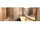 Tiled bathroom featuring a shower-tub combo, vanity sink and mirror, combining functionality and style at 4401 Sprague Rd, Raleigh, NC 27613