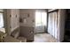 Full bathroom with combined shower and tub, built-in shelving and ample cabinet space at 4401 Sprague Rd, Raleigh, NC 27613