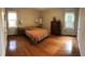 Spacious bedroom featuring hardwood floors, two windows, and ample natural light creates a cozy and inviting atmosphere at 4401 Sprague Rd, Raleigh, NC 27613