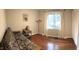 Second bedroom with a futon, hardwood floors, natural light, and closet space, perfect as a guest room at 4401 Sprague Rd, Raleigh, NC 27613