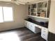 Bonus room with built-in shelving and storage space with dark countertop above lower cabinets at 4401 Sprague Rd, Raleigh, NC 27613