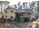 Charming two-story home featuring a cozy covered porch and mature trees at 4401 Sprague Rd, Raleigh, NC 27613