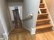 View of the staircase with hardwood steps leading to another room, providing a sense of flow and accessibility at 4401 Sprague Rd, Raleigh, NC 27613