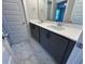 Bathroom features a double sink vanity with modern fixtures and marble-look tiled floors at 502 Yeowell Dr, Chapel Hill, NC 27514
