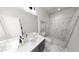 Modern bathroom featuring a double vanity, marble floors, and a glass enclosed shower at 502 Yeowell Dr, Chapel Hill, NC 27514
