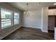 Bright dining area featuring wood floors, large windows, and a modern light fixture at 502 Yeowell Dr, Chapel Hill, NC 27514