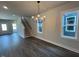 Bright dining area featuring wood floors, large windows, and a modern light fixture at 502 Yeowell Dr, Chapel Hill, NC 27514