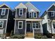 Charming two-story home with a modern exterior, inviting front porch, and freshly landscaped yard at 502 Yeowell Dr, Chapel Hill, NC 27514