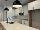 Bright kitchen featuring white cabinets, a microwave, stainless steel appliances, and a kitchen island at 502 Yeowell Dr, Chapel Hill, NC 27514