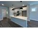 Modern kitchen featuring a large island, stainless steel appliances, and sleek, white cabinetry at 502 Yeowell Dr, Chapel Hill, NC 27514