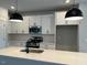 Well-lit kitchen with white cabinets, stainless steel appliances, and a kitchen island at 502 Yeowell Dr, Chapel Hill, NC 27514