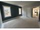 A spacious bedroom under construction with ample natural light, a deep blue wall, and fresh white trim at 504 Yeowell Dr, Chapel Hill, NC 27514