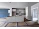 Spacious kitchen featuring white cabinets and a central island, with flooring protection during construction at 504 Yeowell Dr, Chapel Hill, NC 27514