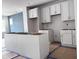 Bright kitchen showcasing white cabinets and a central island, with flooring protection during construction at 504 Yeowell Dr, Chapel Hill, NC 27514
