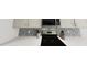 Close up of kitchen with a backsplash and stainless steel appliances, including a microwave above the stove at 504 Yeowell Dr, Chapel Hill, NC 27514