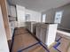 Bright kitchen featuring white cabinets and an island, with flooring protection during construction at 504 Yeowell Dr, Chapel Hill, NC 27514