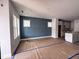 Unfurnished living space with blue accent wall, bright windows, and open layout flowing into the kitchen at 504 Yeowell Dr, Chapel Hill, NC 27514