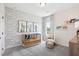 Cozy Bedroom with a patterned accent wall and a window with outdoor views at 52 Commons Cir, Clayton, NC 27520