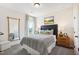 Cozy bedroom with plush carpet, large windows, neutral decor, and full-length mirror at 52 Commons Cir, Clayton, NC 27520