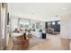 Spacious open-concept living room with hardwood floors, large windows, and a view into the dining area at 52 Commons Cir, Clayton, NC 27520
