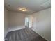 Spacious bedroom with carpet, neutral walls, and entry doorway at 52 Commons Cir, Clayton, NC 27520