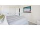 Comfortable bedroom with neutral carpet, bed, mounted TV, and ample closet space at 52 Commons Cir, Clayton, NC 27520