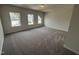 Spacious bedroom with neutral walls, plush carpet, and large windows offering ample natural light at 52 Commons Cir, Clayton, NC 27520