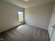 Cozy bedroom featuring neutral walls, carpeted floor, and a window at 52 Commons Cir, Clayton, NC 27520
