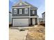 Two-story gray house with a white garage door, complemented by brick accents at the base at 52 Commons Cir, Clayton, NC 27520