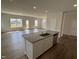 Spacious open floorplan with central kitchen island featuring stainless steel sink and modern dishwasher at 52 Commons Cir, Clayton, NC 27520