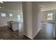 Open-concept living area featuring hardwood floors and large windows for natural light, connected to a kitchen area at 52 Commons Cir, Clayton, NC 27520
