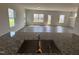 Bright open-concept living room showcasing wood flooring, natural light, and backyard access at 52 Commons Cir, Clayton, NC 27520