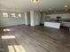 Open-concept living space with hardwood floors, a dining area, and a kitchen featuring granite countertops at 52 Commons Cir, Clayton, NC 27520