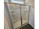 New shower features sliding glass doors, white tile, and built-in shelving at 52 Commons Cir, Clayton, NC 27520