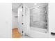 Bright bathroom featuring marble tile, a shower-tub combo, and walk-in closet at 523 S West St # 409, Raleigh, NC 27601